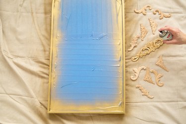 spray painting mirror and wood with gold paint