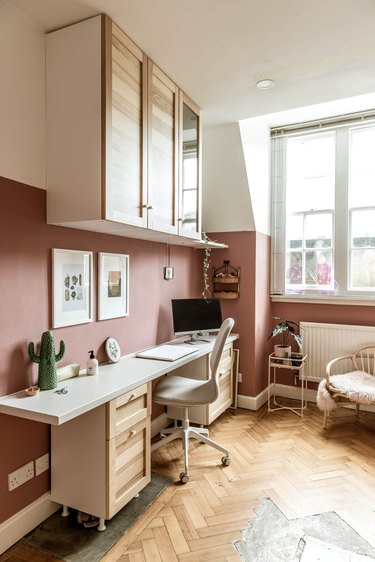 modern home office with pink colorblock walls and light wood furniture