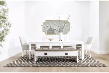 dining room with white bench, table, and chairs