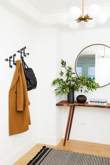 scandinavian hallway with small table and coat rack