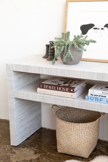 Ikea Hack grasscloth console table styled with books, plants, basket