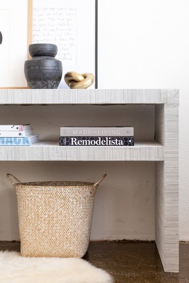 Ikea Hack grasscloth console table styled with books, plants, basket