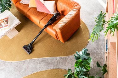vacuum leaning on couch