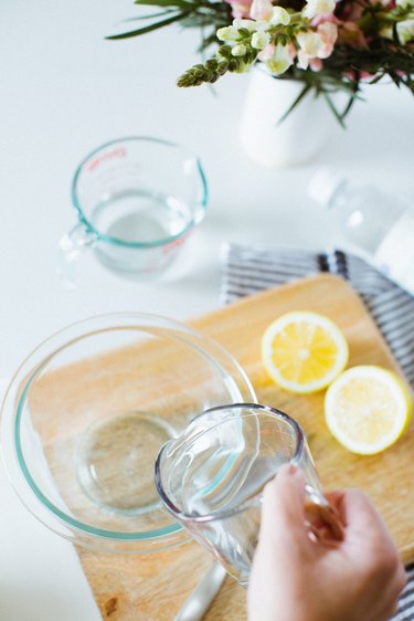 Combine water and white vinegar to clean the microwave