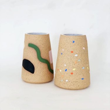 two ceramic pieces with colorful designs