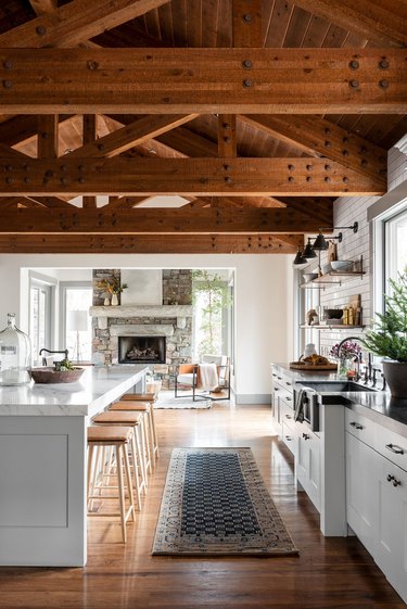Farmhouse kitchen with exposed beams and vintage runner by Studio McGee