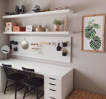 soothing office for two with shelving above pegboard