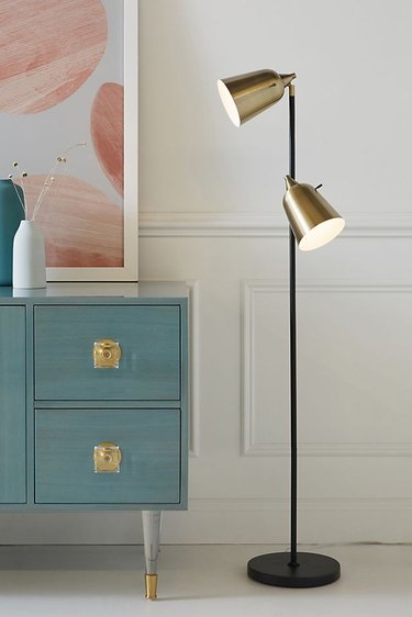 brushed brass metal Bedroom Floor Lamps next to blue bedroom drawers