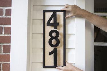 Hanging DIY modern wood address plaque to porch wall