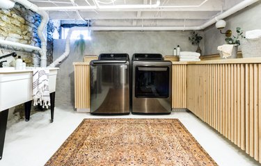 unfinished basement idea with laundry and counter and rug