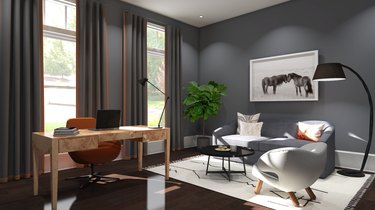 burl wood desk in home office with seating area and grey walls