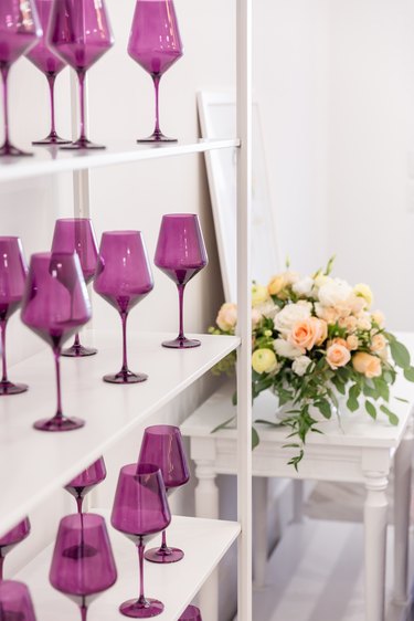 wine glasses in bookcase by Estelle Colored Glass