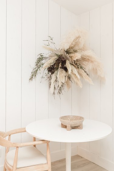 Fall floral arrangement hung over table