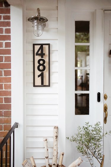 DIY modern house numbers hung underneath industrial style porch light