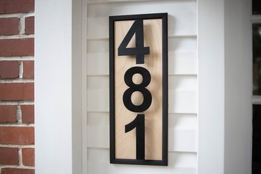 DIY modern house numbers with wood plaque mounted on front porch wall