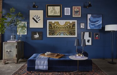 color meaning in eclectic blue dining room with gallery wall
