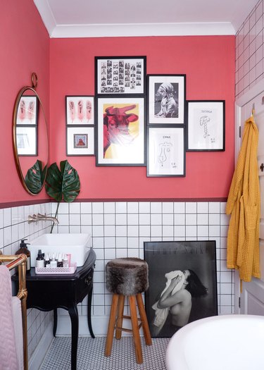color meaning in modern pink bathroom with gallery wall