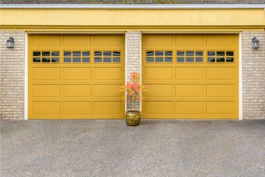 Yellow garage door colors on light brick house.
