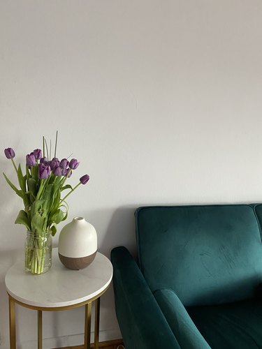 flowers and vase on table near chair