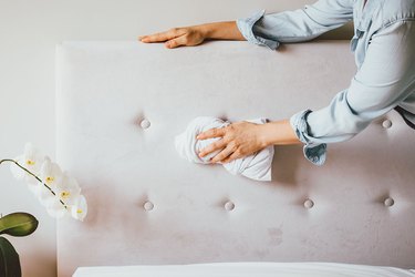 Gently blot headboard stains to clean