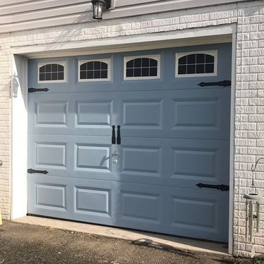blue garage door with window decals and hardware