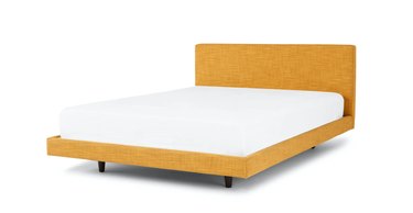 yellow bed frame with white mattress