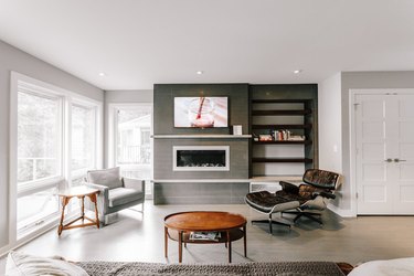 contemporary fireplace mantel with a concrete mantel by Anne McDonald Design