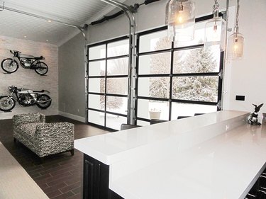Garage bar ideas with glass garage doors and motorcycles on the wall