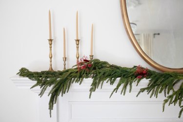 Holiday mantel garland decorated with berry-colored dried floral sprays