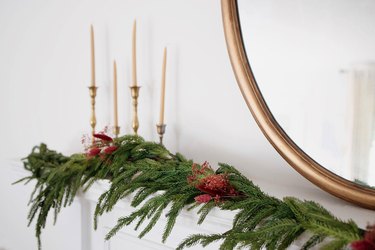 Holiday mantel garland decorated with berry-colored dried floral sprays