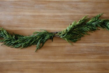 Two pine garlands arranged in center of wood table