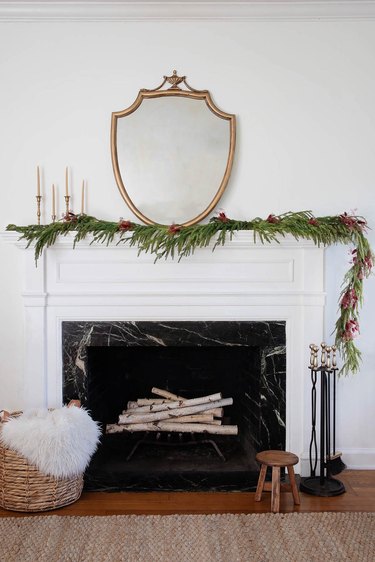 Asymmetrical mantel garland decorated with berry-colored dried floral sprays