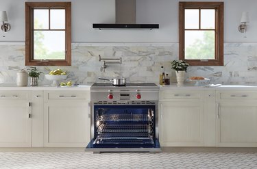 white kitchen with open Wolf stove