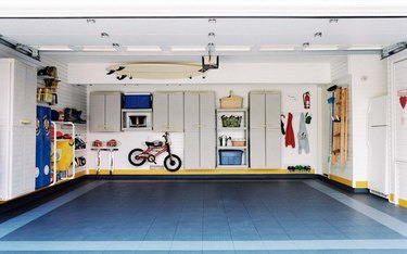 Organized, clean garage with floating shelves and cabinets with Garage Wall Shelving Ideas