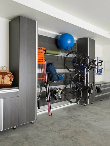 Organized garage storage with cabinets and hooks with Garage Wall Shelving Ideas