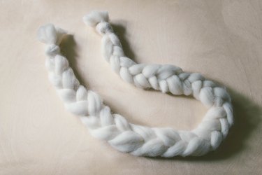 Braided strand of ivory wool