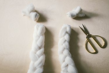 Knots cut off ends of braided wool