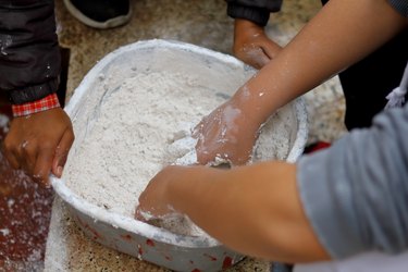 Mixing plaster of Paris in a bowl.