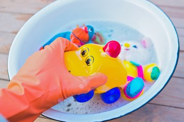 washing toy car with soap and water to disinfect it - top