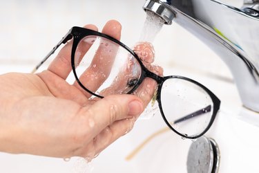 Cleaning eyeglass lenses to be clean and clear to prevent COVID 19