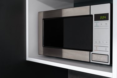 Stylish microwave oven with timer in kitchen