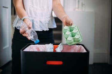 Woman recycling at home