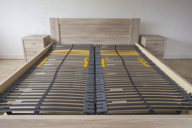 Slatted base, wooden element double bed frame close up in bedroom orthopedic