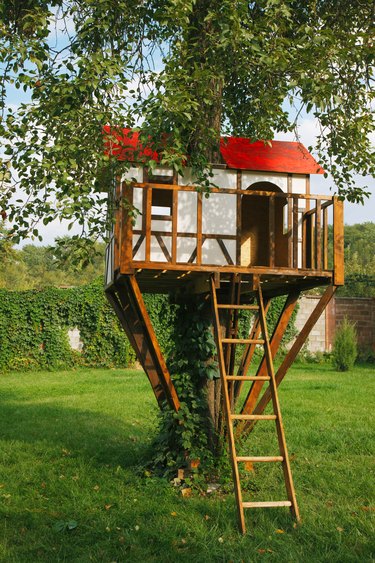 Cute small tree house for kids on backyard.