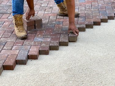 Laying brick pavers for new patio.