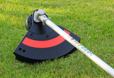 Weed trimmer in red and black on the grass