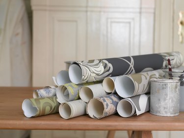 Rolls of wallpaper on decorating table.