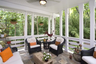 Peaceful enclosed back deck/porch with furniture