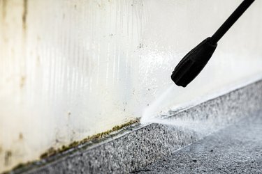 Cleaning a concrete wall.