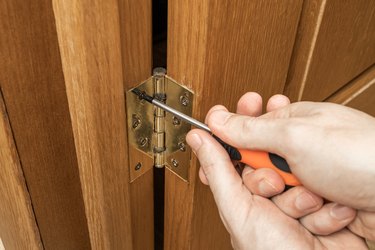 indoors door loop repair or fix. handyman carpenter adjusting creak hinge
